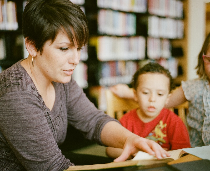 Lady Reading with Two Young Students