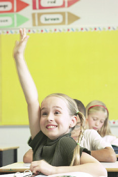Young Blonde Student Raising Hand in Class